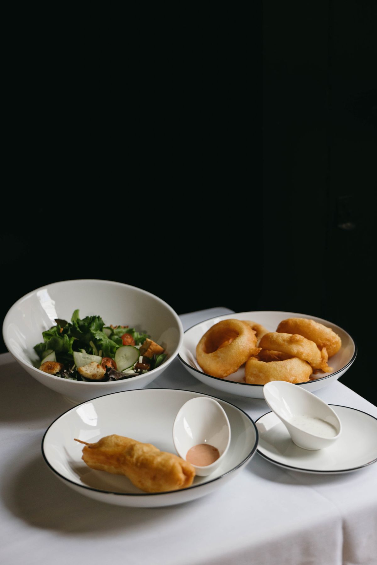 Appetizer salad, onion rings and corndog