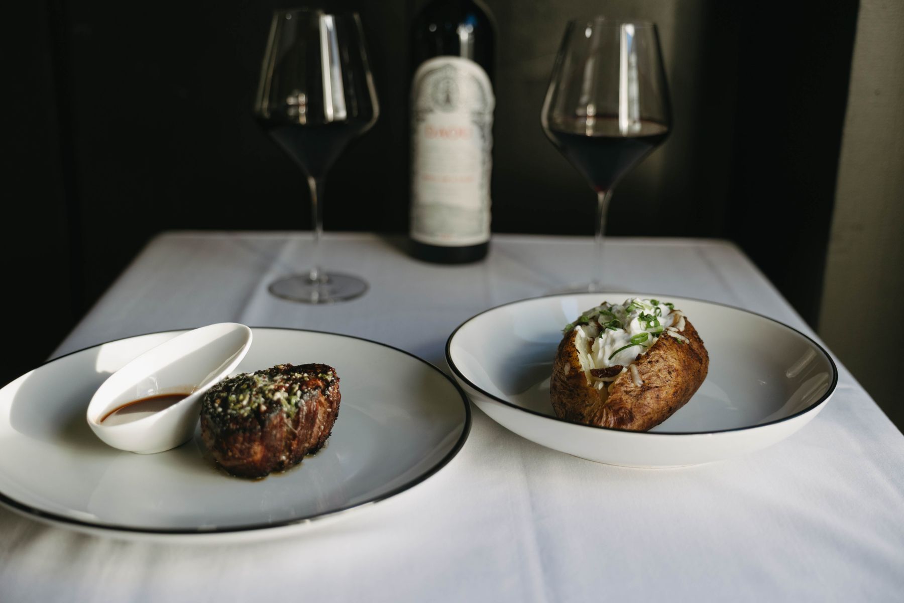 Filet and loaded baked potato with red wine