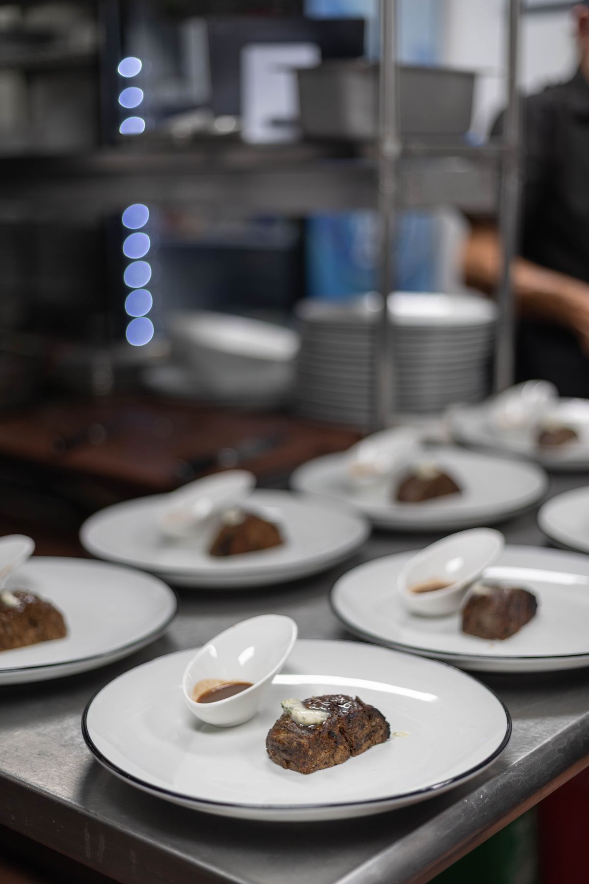 Chophouse kitchen plating steaks for a group