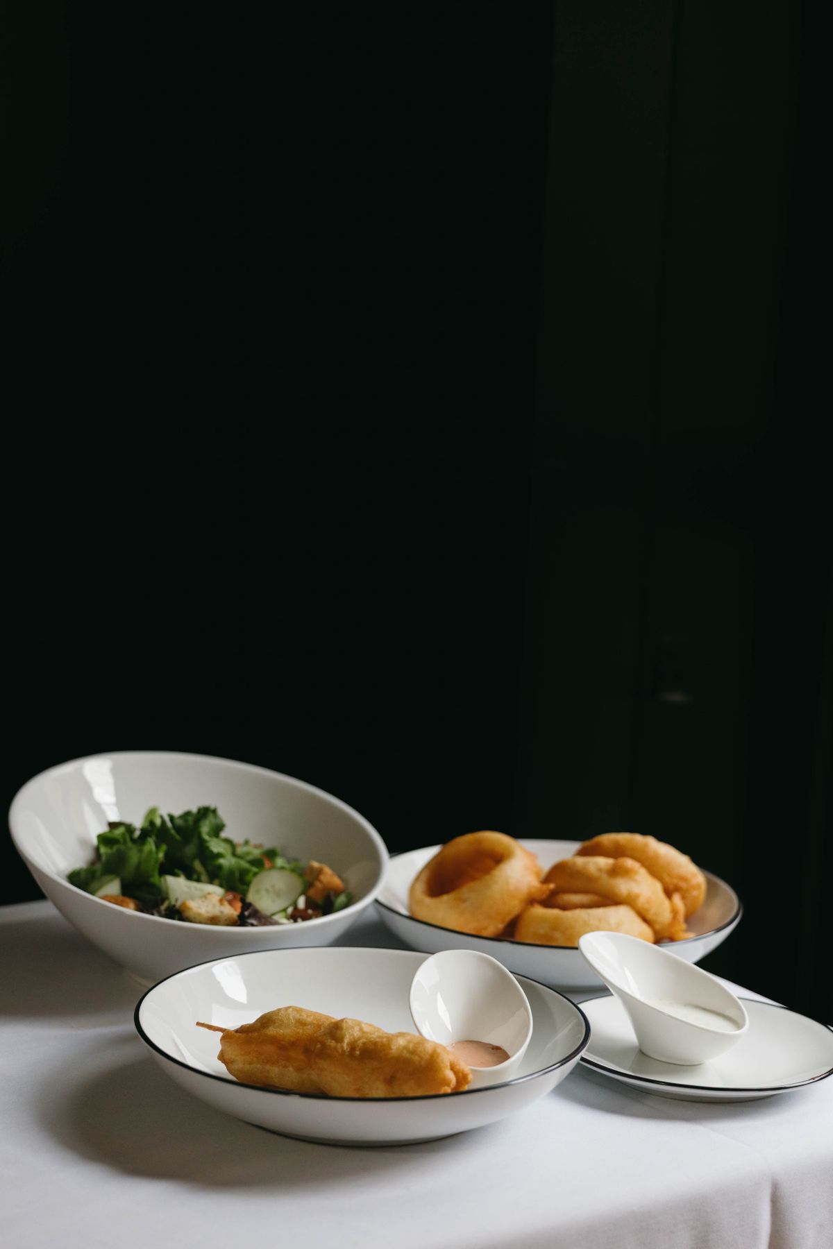 Lobster corndog with salad and onion rings