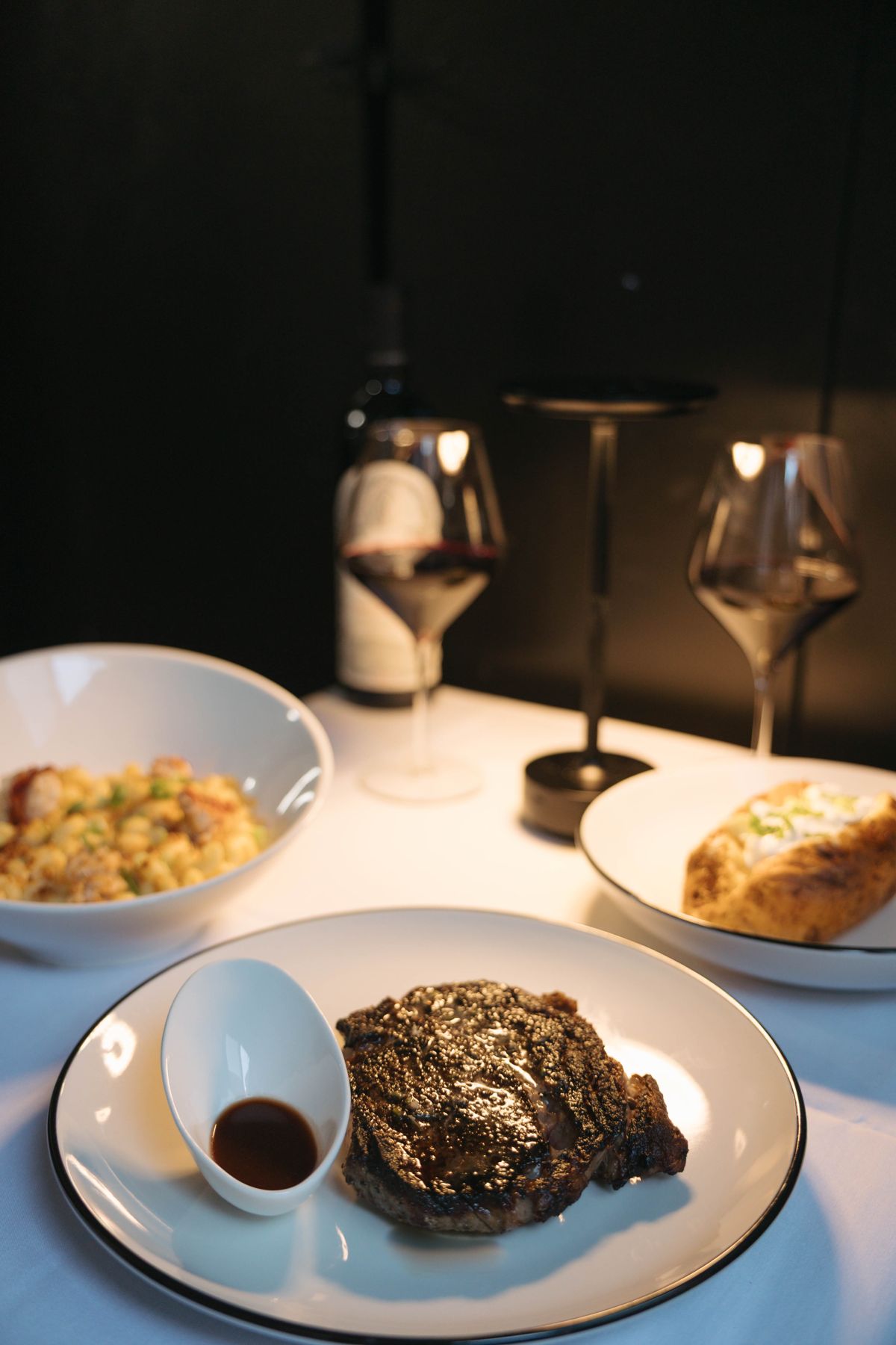 Steak with mac and cheese and baked potato